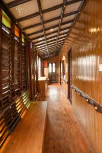 a hallway with a wooden bench in a wine cellar at St. Mary Houseboat in Kumarakom