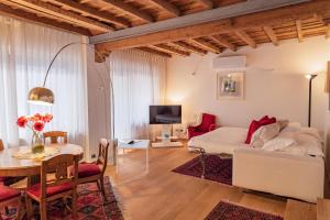 a bedroom with a bed and a dining room with a table at Como Icon Centro Apartment By Icon7 Luxury in Como