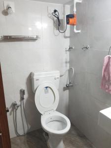 a small bathroom with a toilet and a shower at A Private Room With Terrace in Ahmedabad