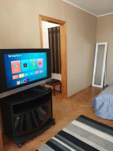 a living room with a flat screen tv on a stand at Велика 1к квартира біля метро Лівобережна вулиця Флоренції 1 in Kyiv