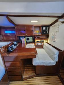 a small room with a desk and a table in a boat at The Sailboat Home BCN in Barcelona