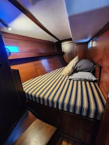 a small bed in the back of a boat at The Sailboat Home BCN in Barcelona