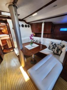 a living room with a table on a boat at The Sailboat Home BCN in Barcelona