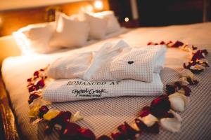 a pile of towels sitting on top of a bed at Crystal Creek Rainforest Retreat in Crystal Creek