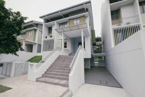 a white house with stairs in front of it at 3StoreyFamilyFriendly LakeVilla@Putrajaya@BathTub in Putrajaya