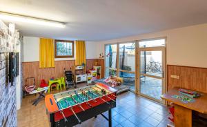 a living room with a table and a play room at Residence Alpina in Tesimo