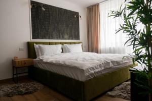 a bedroom with a bed with a large window at Scandinavia Apartment 2 in Piatra Neamţ