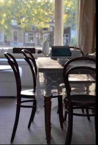 a dining room table with two chairs and a laptop on it at Hemels logeren LUXURY LOFT Zutphen in Zutphen +17 photos