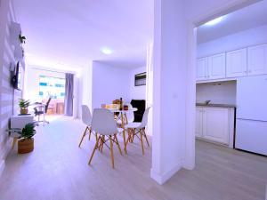 a kitchen and living room with a table and chairs at Tropicalidays Sunset Palm in Costa Del Silencio