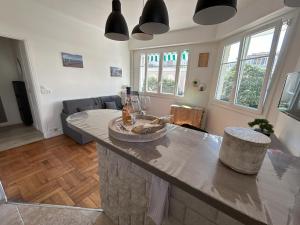 a kitchen and living room with a large counter top at Le 29 Promenade des Anglais - Golden Square in Nice