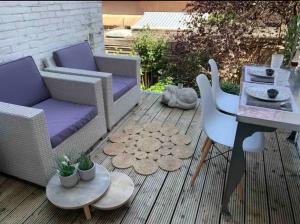 a patio with a table and chairs and a table and a tableablish at Hemels logeren LUXURY LOFT Zutphen in Zutphen