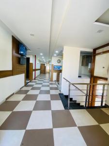 a hallway with a checkered floor in a hospital at The Woodlark !! Managed by Sidham Hospitality !! in Chandīgarh