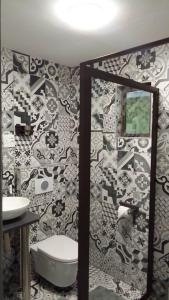 a bathroom with a toilet and a sink and a mirror at Kangumine Self Catering Units in Okakarara +70 photos