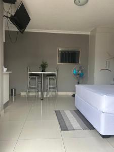 a living room with a bed and a table and chairs at Kangumine Self Catering Units in Okakarara