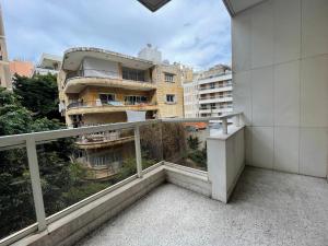 a balcony with a view of a building at Elegant Suites Beirut in Beirut