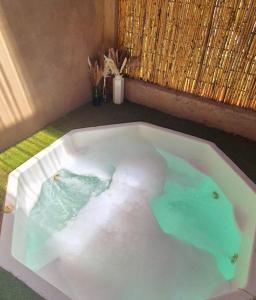 a white bath tub filled with water in a room at Hide Away Wedding,Conference & Function Venue in Bela-Bela