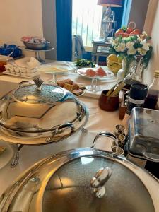 a table with plates of food and a sink at Quattro Gigli Palace in Montopoli in Val dʼArno