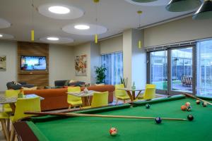 a billiard room with a pool table at Sadot Hotel Ben Gurion Airport - an Atlas Boutique Hotel in Assaf Harofeh