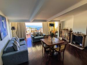 a living room with a couch and a table at Taormina Palazzo di Ferro in Taormina +38 photos