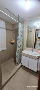La salle de bains est pourvue d'un lavabo et d'une douche avec un miroir. dans l'établissement The Modern Stay U-Residence with City View, à Klapadua