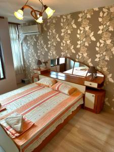 a bedroom with a large bed in a room at Lux Apartment Sisi in Burgas City