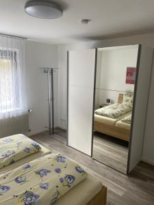 a bedroom with two beds and a mirror at Ferienwohnung Traumschleife Klettersteig in Boppard