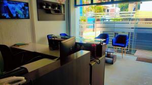 an office with a desk with a computer and chairs at PRIME SUITES in Bengaluru