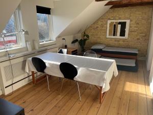 a living room with a table and a couch at Townhouse in Odense