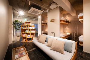 a living room with a couch and bunk beds at MANGA ART HOTEL, BAKUROCHO in Tokyo