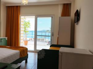 a room with two beds and a view of the ocean at Yazıcı Otel Bozburun in Marmaris