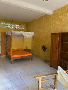 a bedroom with an orange bed in a room at Spices Beach Studio Madirokely Nosy Be in Nosy Be