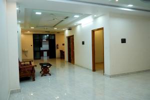 a hallway with a room with a table in it at Alexa Service Appartments (1BHK,2BHK with Kitchen) in Tirupati