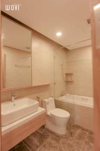 a bathroom with a toilet and a sink and a tub at Wins House - FLC Sea Tower Quy Nhơn in Quy Nhon