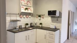 a kitchen with a sink and a counter top at Éden Villa Apartmanház 2 in Balatonfüred