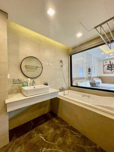 baño con lavabo y ventana grande en Wins House - FLC Sea Tower Quy Nhơn en Quy Nhon