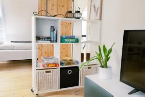 a room with a book shelf and a tv at Vila Ana - 2 room apartment in Vejle