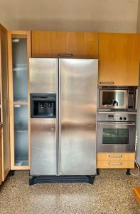 a kitchen with a stainless steel refrigerator and microwave at Il Duomo,150 meters. Charm Home in Downtown in Vicenza +39 photos