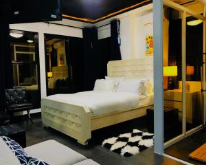 a bedroom with a white bed with a mirror at Gmb-Arte' Hotel in Sogod