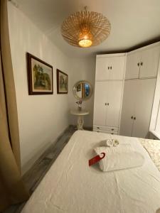 a bedroom with a white bed with a redhibahibahibahibahibahiba at Barcelona with rooms and lofts in front of the tourist metro stop in Barcelona
