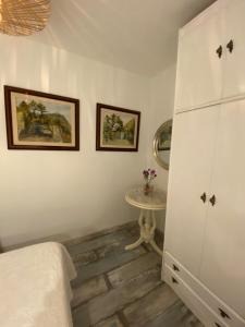 a bedroom with a white cabinet and a table at Barcelona with rooms and lofts in front of the tourist metro stop in Barcelona