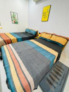 a room with two beds sitting next to each other at TINA HOUSE Apartment in Da Nang