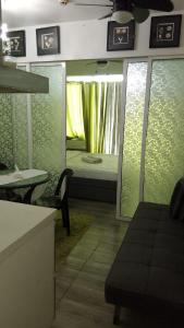 a room with a room with a bed and a table at 1bedroom with balcony in Manila