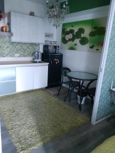 a kitchen with a table and a small table with chairs at 1bedroom with balcony in Manila