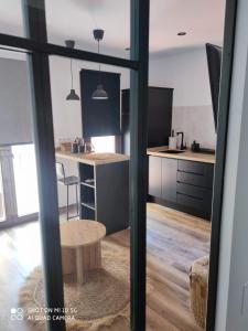 a kitchen with black cabinets and a table at EL REFUGIO DE CARMEN 1 B in Almuñécar +5 photos