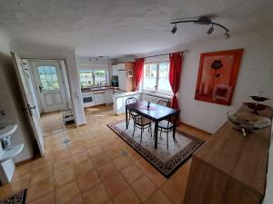 a living room with a table and a kitchen at Ferienwohnung "Am Seebach" in Wangen im Allgäu