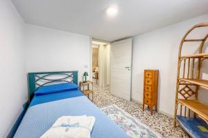 Casa vacanze Cetto e Vera في غالاتينا: غرفة نوم بسرير ازرق وسلم
