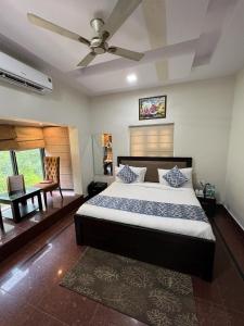a bedroom with a bed and a ceiling fan at Namanbagh in Alwar