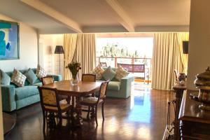 a living room with a table and a couch at Taormina Palazzo di Ferro in Taormina