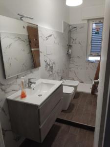 a bathroom with a sink and a toilet at Marina Sea View in Marina di Gioiosa Ionica