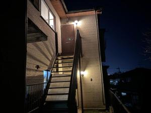 una escalera que conduce a un edificio con luz en Kumamoto Castle House, en Kumamoto